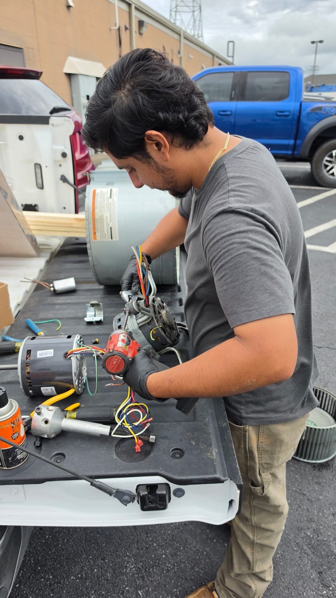 HVAC technician preparing replacement parts
